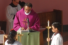 Father Karippai reads the Gospel